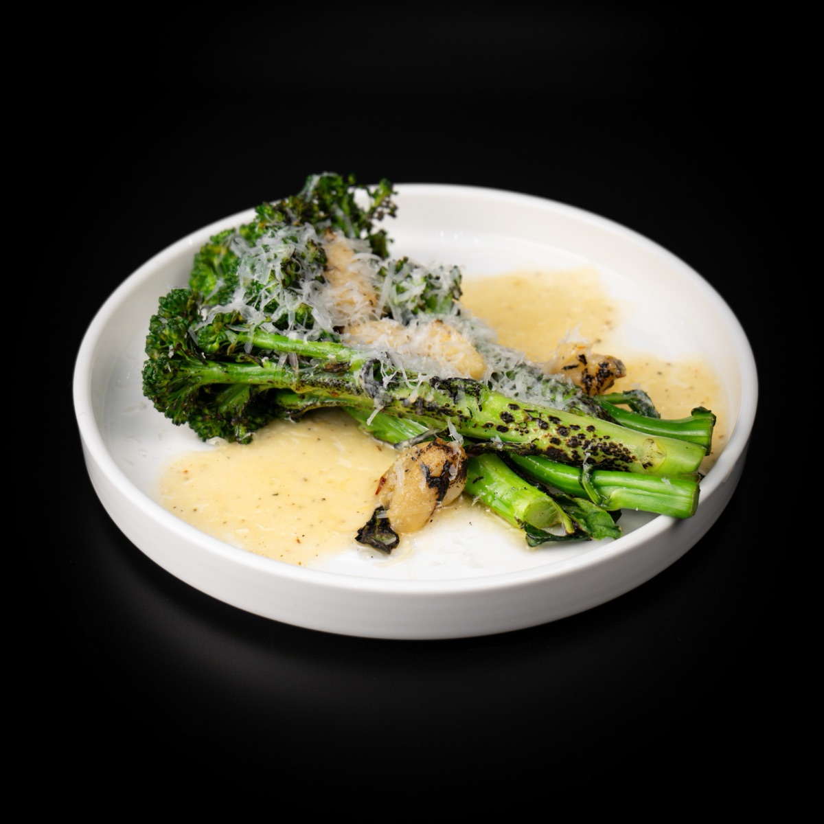 Charred broccolini with roasted garlic and grated cheese